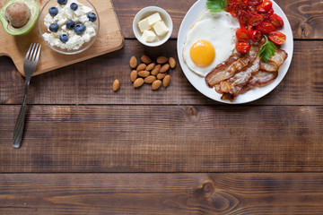 Keto breakfast on wood background. Top view.