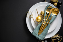 Gold Cutlery Served On Plate For Christmas Dinner