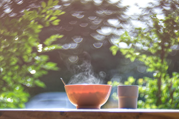 Beautiful curl of team from rice in a hot bowl with bubble blur background