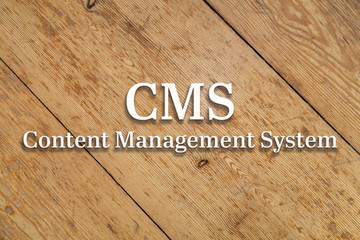 Wall Mural - `ecms content managemnt system` white text on a wooden home background.