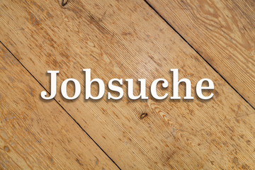 Wall Mural - `jobsuche` white text on a wooden background. translation: `job search`