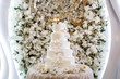 Wedding cake on the background of the flower arch