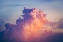 Close-up Colorful Clouds Going Up In Sunset Sky. Natural Phenomena. Atmospheric Environment. Splash Of Rose, Scarlet And Blue Tints. Great Background For Different Kinds Of Collages And Illustrations.