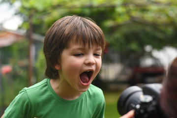 Wall Mural - Angry boy. Little boy eating ice cream. Boy screams and eats ice cream