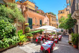 Fototapeta Uliczki - Street view with cafe in old town Taormina. Sicily, Italy