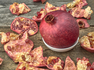 Delicious juicy red pomegranate.On wooden background