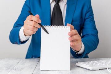 Wall Mural - Man holds empty paper with copy space in front of him. White space for advertising message.