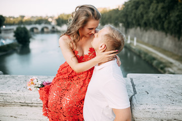 Stylish loving couple walking and laughing. Wedding shooting on the streets of Rome, Italy.