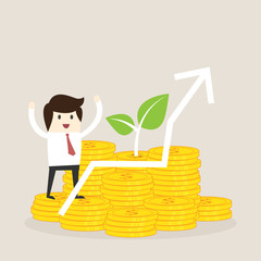 Wall Mural - business man stand on money gold with green leaf and stock graph,saving investment