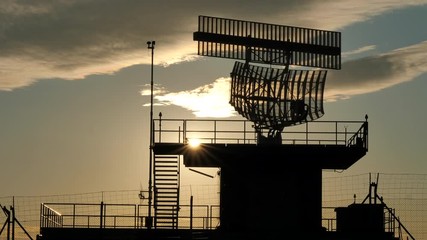 Silhouetted view of an all-around antenna for air defense and tracking made of phased array technology on a rotating platform