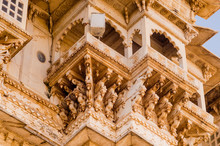 Carved Sandstone Exterior Walls Of The Udaipur Palace With Arches, Balcony And Windows