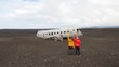 plane wreck on beach in Iceland with friends celebrating 