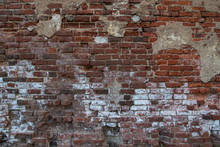 Wall Of Old Red Brick With Remnants Of Fallen Plaster