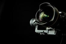 Close-up Of Wide Angle Lens In A Dsl Camera And Gimbal Stabilizer, With Low-key Lighting And A Black Background
