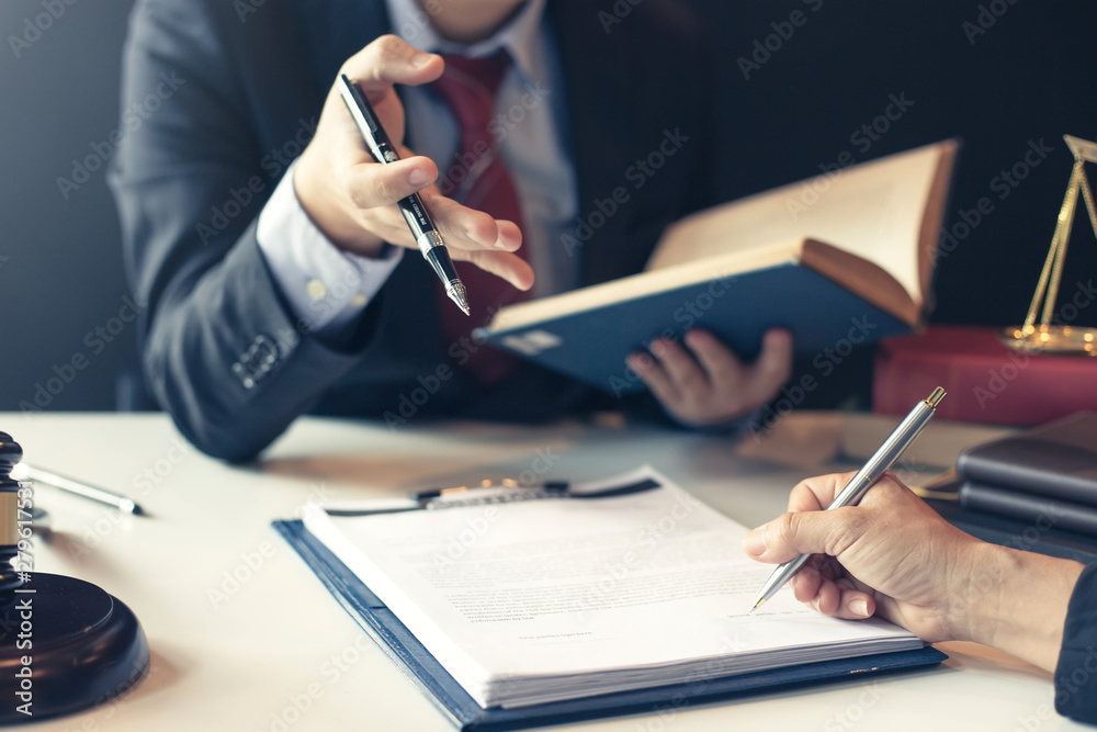 Businessman and lawyer discuss the contract document. Treaty of the law. Sign a contract business. - obrazy, fototapety, plakaty 