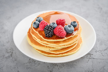 Wall Mural - Pancakes with fresh berries and maple syrup