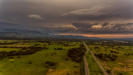  sunset over green field