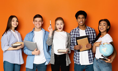 Teen friends with copybooks and earth globe