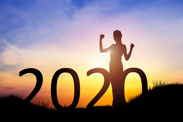 silhouette of young woman cheerful on the hill with 2020 happy new years. conceptual image of freedo