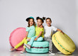 © FAB.1 - Three friends of triplets - two girls and a boy in bright clothes have fun at the birthday party fun room decoration candy macarons