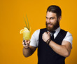 bearded barman with beard holding cocktail in waistcoat