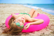 Happy Girl Sunbathing On Beach.