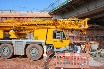 Wall Mural - Mobile crane by a bridge under construction