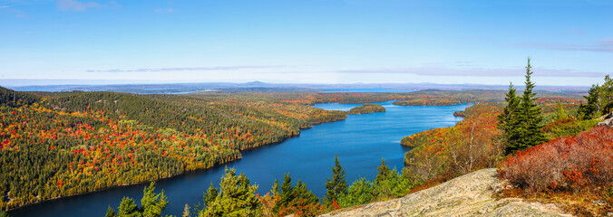 panoramic aerial view of the blue water and fall foliage surrounding long pond in acadia national pa