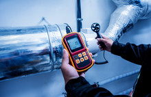 Technician Use Hand-held Anemometer Measuring Air Flowing Measurement, Wind Speed And Pressure.
