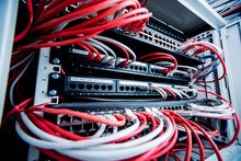 Network Switch And Ethernet Cables In Red And White Colors. Data Center