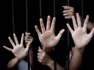 women and children in catch the iron prison, human trafficking concept, human rights violations,