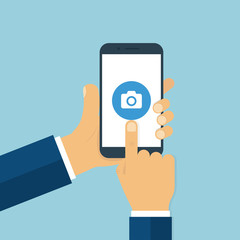Poster - Hand holding smartphone clicking camera sign. Photo concept. Mobile screen touching. Trendy flat design.