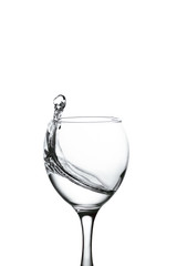 Wall Mural - splash of water in wineglass isolated on white background.