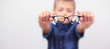 Banner little boy with glasses correcting myopia close-up portrait Ophthalmology problem selective focus