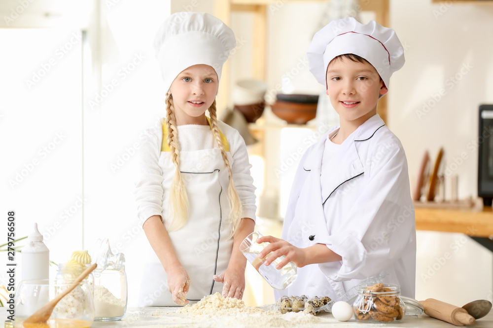 Cute little chefs cooking in kitchen