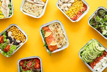 Many Containers With Delicious Food On Color Background