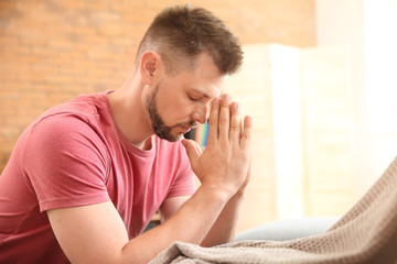 Wall Mural - Religious man praying at home