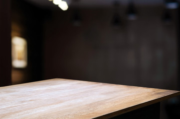 empty wood table with blur montage coffee shop or restaurant background.