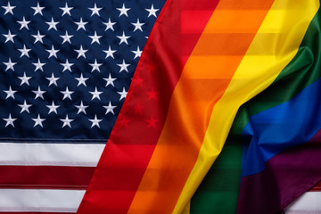 Pride rainbow lgbt gay flag over American US flag . Equality freedom in USA concept.