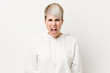© Asier - Young curvy woman wearing a white hoodie screaming very angry and aggressive.
