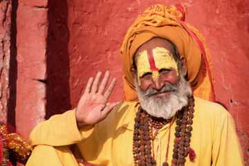 Sadhu man with traditional painted face in Pashupatinath Temple of Kathmandu, Nepal.Sadhu man refer to holy person.Nepal text in photo refer to prayer word om mani padme hum