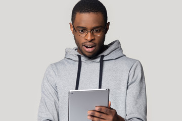 Sticker - Surprised black male look at tablet amazed by unexpected news