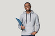 © fizkes - Smiling black male student stand holding binder case