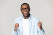 © fizkes - Excited black male in glasses feel overjoyed with news