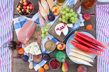 Picnic on the beach at sunset in the style boho, food and drink conception