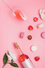 Wall Mural - Summer flat lay with rose wine, delicious strawberries and beautiful peonies