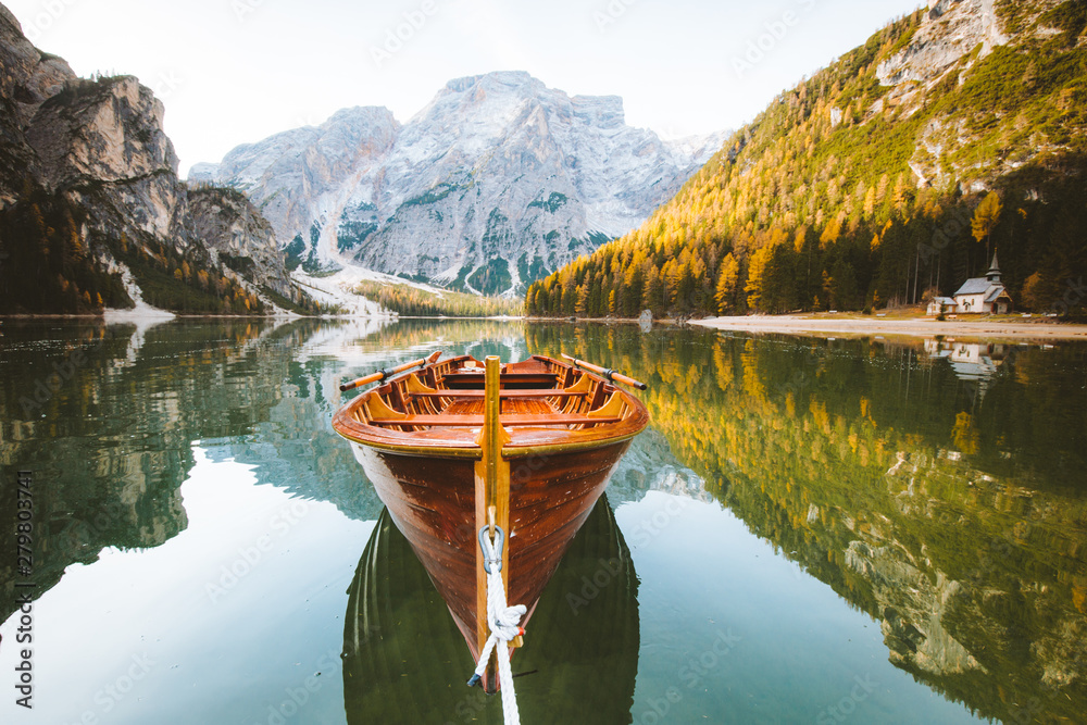 Traditional rowing boat on a lake in the Alps in fall - obrazy, fototapety, plakaty 