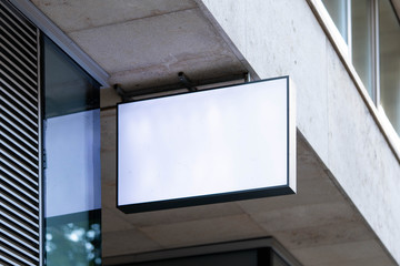 Wall Mural - Blank store signboard mockup. Empty shop signage template mounted on the wall. Street sign, 3d rendering.