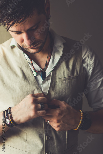 Cuadros en Lienzo Cool elegant casual man with bracelets, rings and pearcings