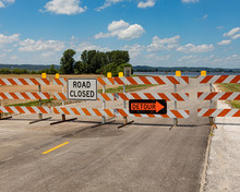 Barricades And Signs Ward Of A Road Being Closed Due To Flooding Along The Mississippi River